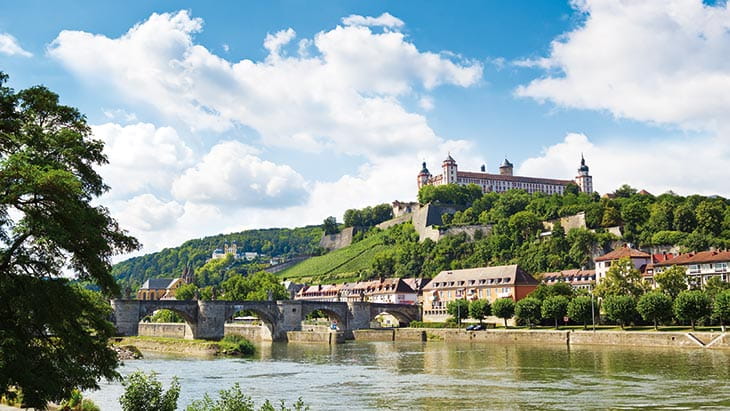 A view over the Main River towards the Alte Mainbruecke and the Festung Marienberg from Wurzburg, Germany